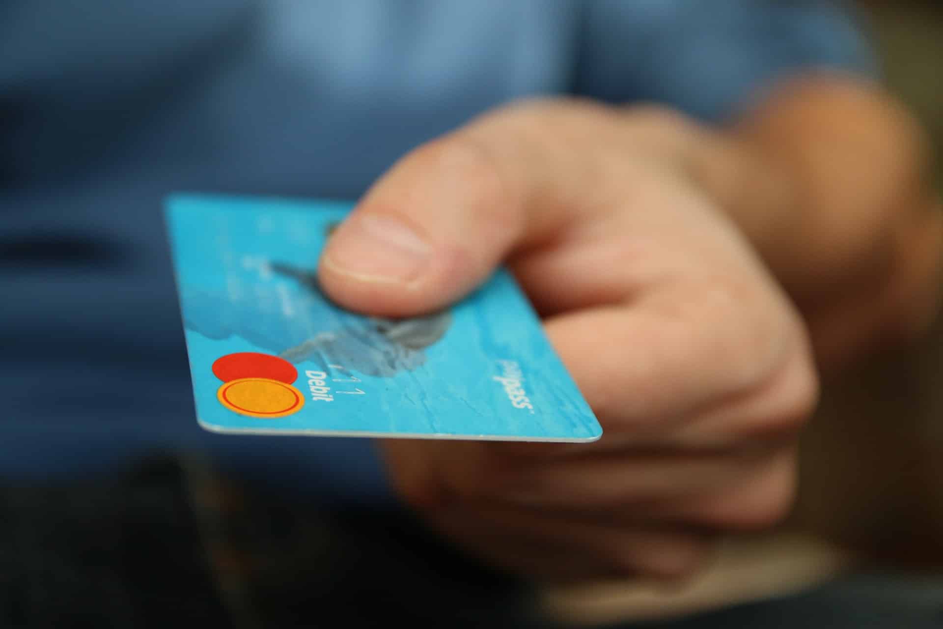 5 drivers transactions - man handing credit card
